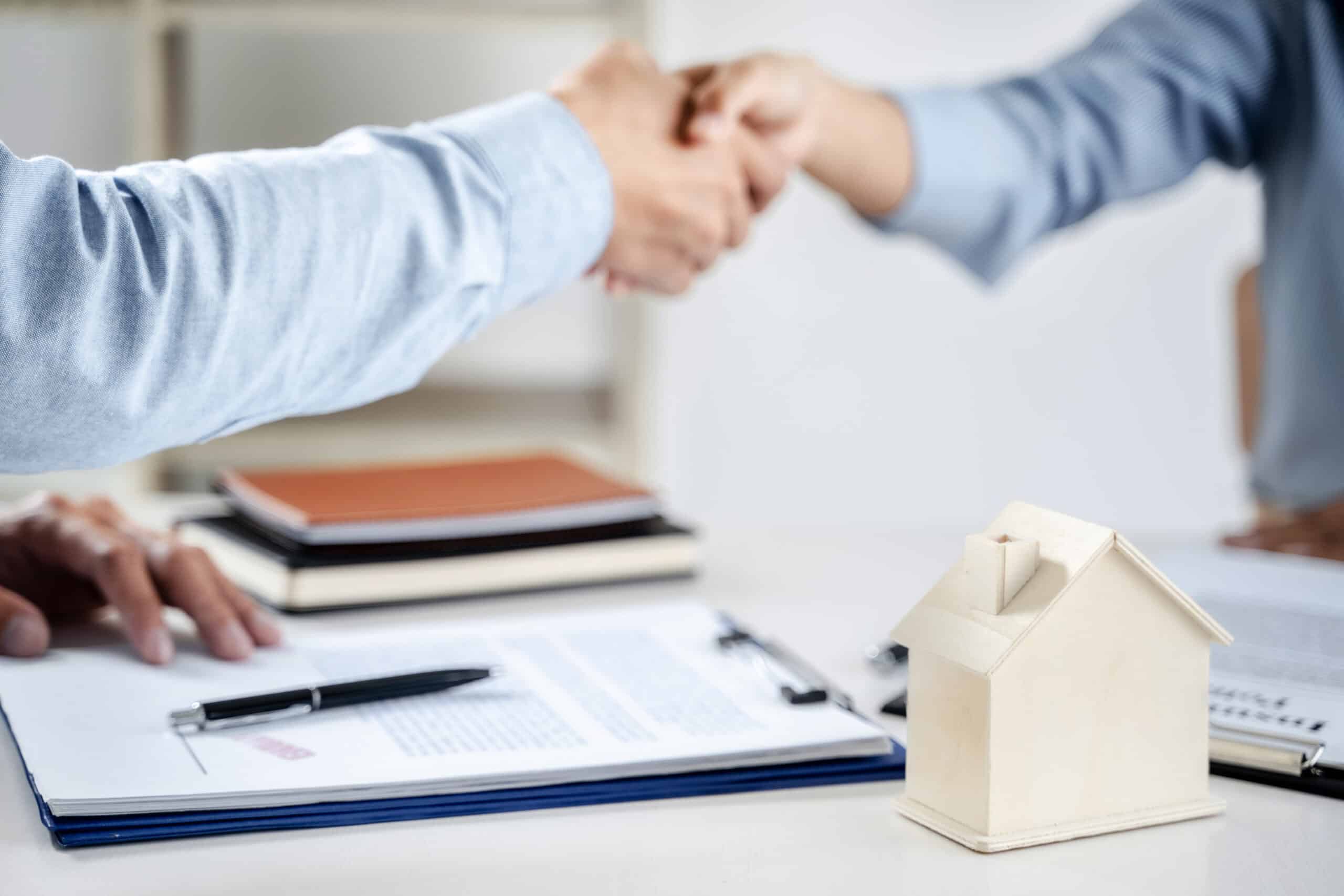 Business meeting Handshake. home loan insurance. .Real estate broker and client  sign contract insurance agreement document